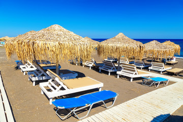 Fototapeta na wymiar Santorini Perissa beach with black sand Santorini island, Greece
