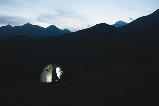 Man camping in the mountain at night