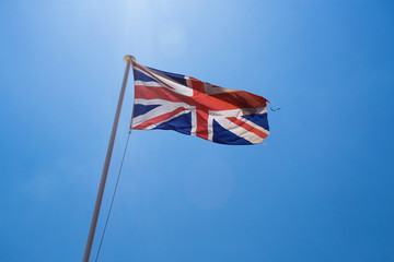 English flag floating in the wind over the sky