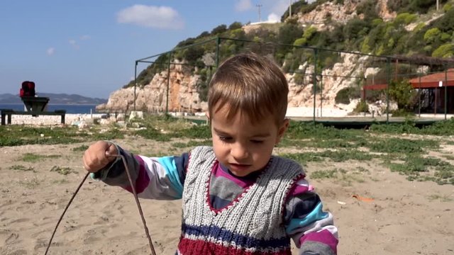 Child waving bye-bye at the seaside