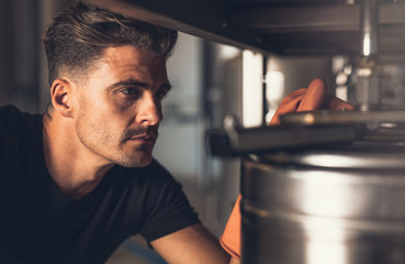 Male brewer working at brewery