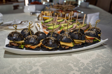 Homemade minihamburgers with black buns