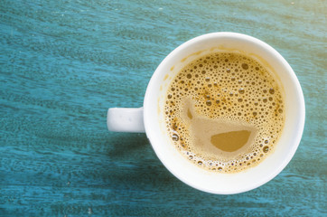 coffee cup top view closeup isolated on a vintage wooden desk.