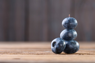Pyramid made of veal blueberry on an old wooden background with copy space. Fresh blueberries. Blueberry