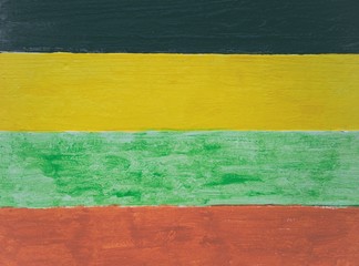 Jamaican reggae colors on wood panel background