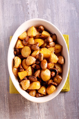 Baked potatoes and mushrooms in  a tin