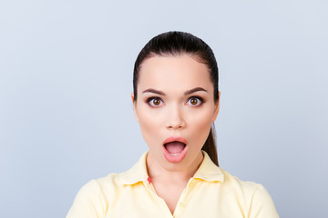 No way! Close up portrait of amazed young freelancer brunette lady, she stands in yellow tshirt on pure light background, shocked