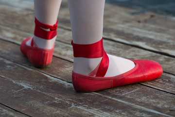 Red ballet shoes with white socks in ballerina.