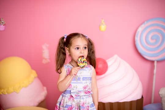 beautiful cute little girl eating lollipop