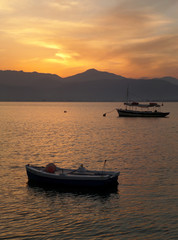 Naklejka premium Two Fishing Boats on Aegean Sea at the Sunset, Nafplio, Greece