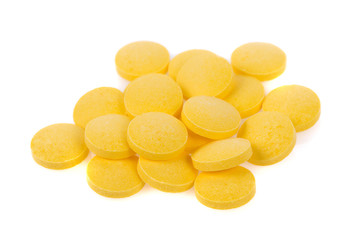 Yellow pills isolated on white background