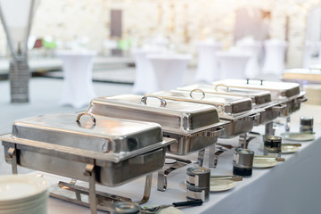 Buffet heated trays standing in line ready for service. Outdoors buffet restaurant, the hotel...