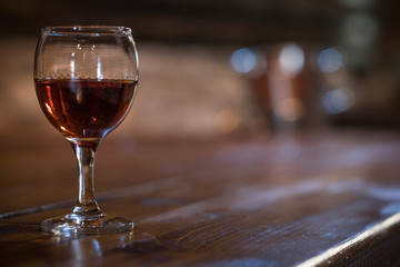 Half filled glass of wine with defocused background