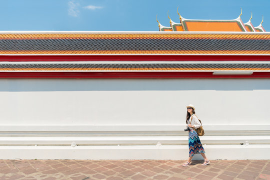 Woman tourist walking in Wat Pho temple