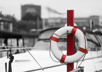 red lifebelt in front of a marina