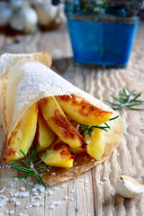 French Fries. Fried Potatoes. Baked Potato Wedges, Slices of Baked Potatoes with Garlic and Rosemary. Rustic Food Style