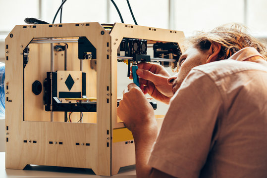 Technician working with 3d printer