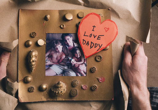 Opening Father's Day Gift: Faded Photo in Childs Frame