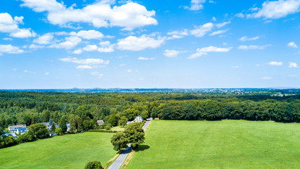 Drone flight in the summer above the are of Aachen with its flields, forest and meadows