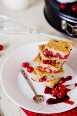 Cake, dessert and pastries, biscuit pie with cherry, raspberries and milk on a light background 