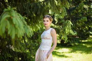 Portrait of young tender happy girl. Caucasian woman model posing in the forest