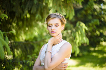 Portrait of young tender teenage girl. Caucasian woman model posing in the forest