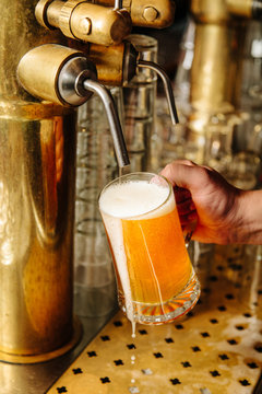 Man filling beer mug from tap