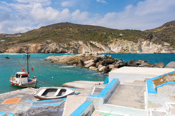 Traditional Greek fishing boats anchoring in Mandrakia village. Milos Island, Greece.