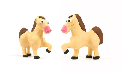 Cute horse modeling clay isolated on white background. Handmade plasticine. Close up.