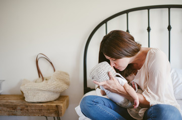 Mother cuddling newborn son
