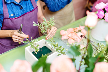 Girl florists working in the Studio over the bouquet