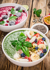 Smoothie bowl with fresh berries, nuts, seeds, fruit and vegetables.