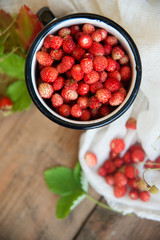 Wild strawberry basket on wooden background