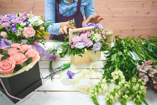 The florist makes the bouquet top view on background white Board