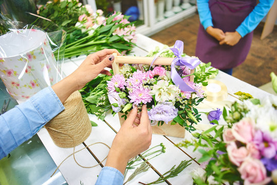 The florist makes the bouquet top view on background white Board