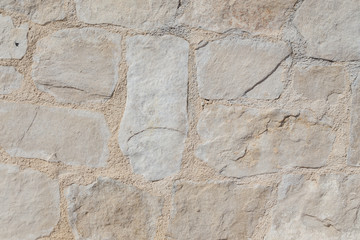 Pattern of the ancient style stone wall with cement.