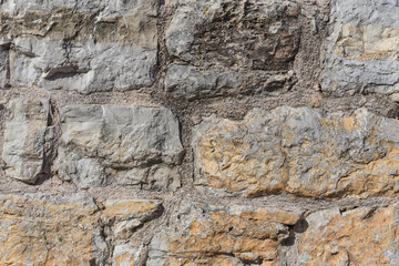 Pattern of the ancient style stone wall with cement.