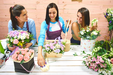 Three girls florist working with flowers