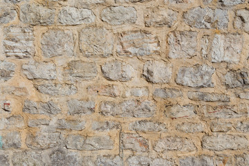 Pattern of the ancient style stone wall with cement.