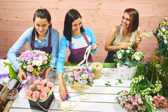 Three girls florist working with flowers