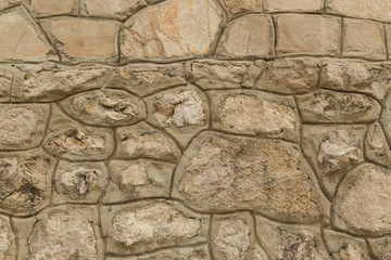 Pattern of the ancient style stone wall with cement.
