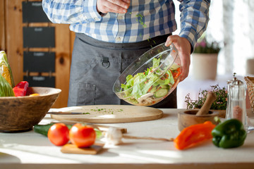 male cooking healthy salad