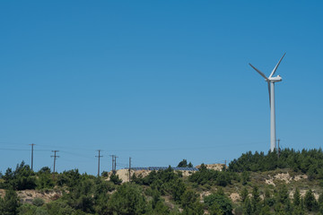 Wind Turbine and Solar Panels over the Mountain