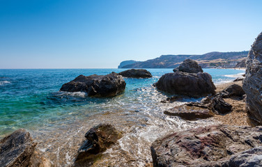 Rocks in crystal clear turquise waters of paliochori beach in Milos island, Greece