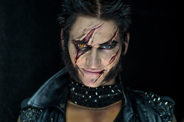 Professional make-up werewolf Wolverine with scars and orange eye