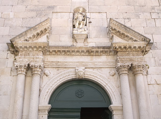 Detail of the church entrance door, Facade of old church in Omis, Dalmatia, Croatia