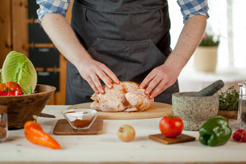 Obraz na płótnie Canvas male preparing chicken for cooking