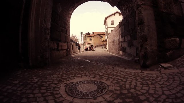 View Through Arch on Little Street of Old Ankara People Walk About Their Business