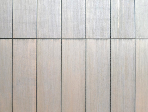 modern steel cladding panels on a building with a shiny rust finish
