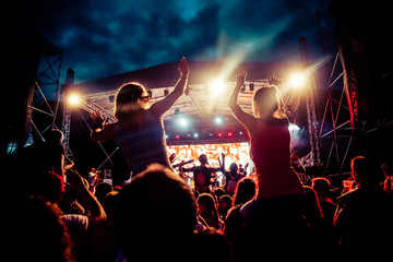 crowd with raised hands at concert - summer music festival